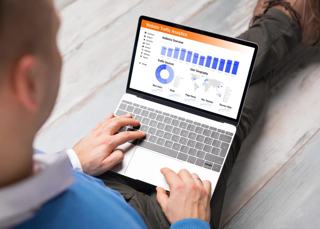 Man analysing his website's traffic on his laptop after doing On-Page SEO.