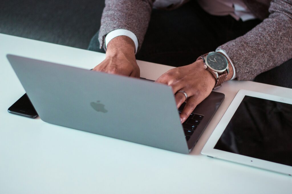 Man with stylish watch on working on his website's on-page SEO on his laptop.