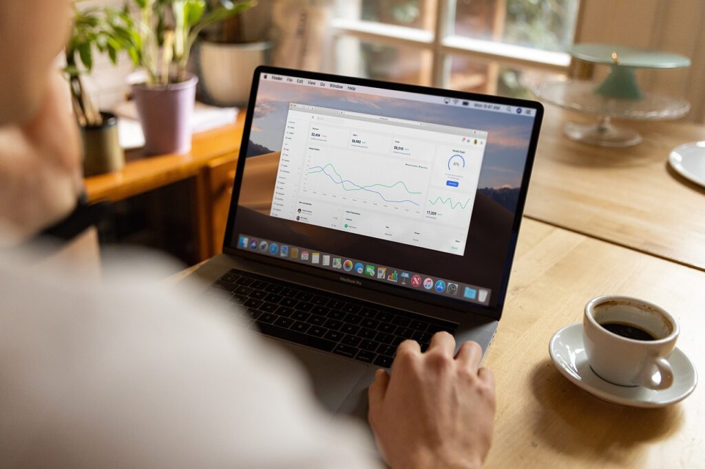 Man on his laptop analysing his site's traffic after doing SEO.