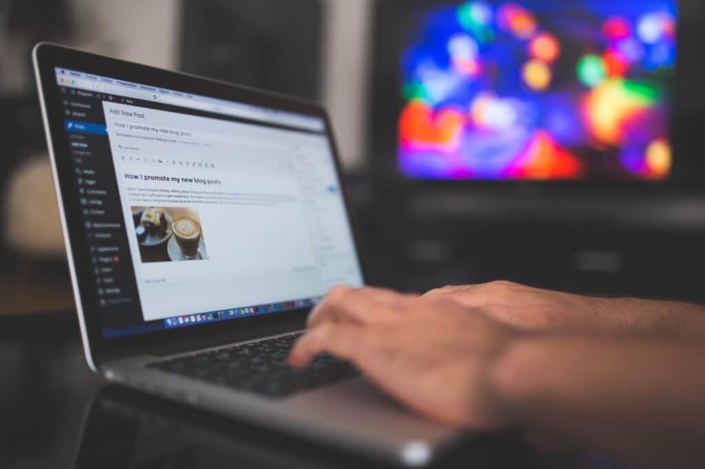 Man writing a blog post for his website.